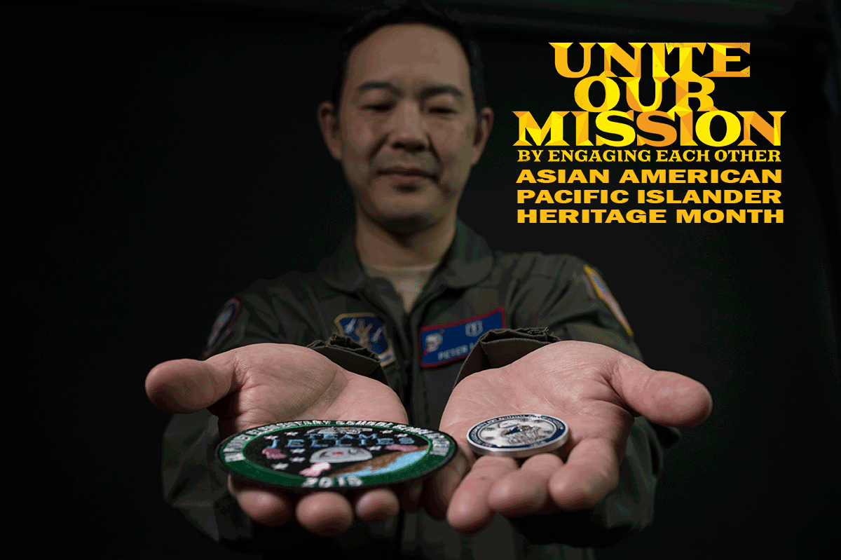 Lt. Col. (Dr.) Peter Lee holding out coin and patch
