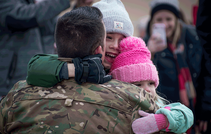 Children hug Soldier
