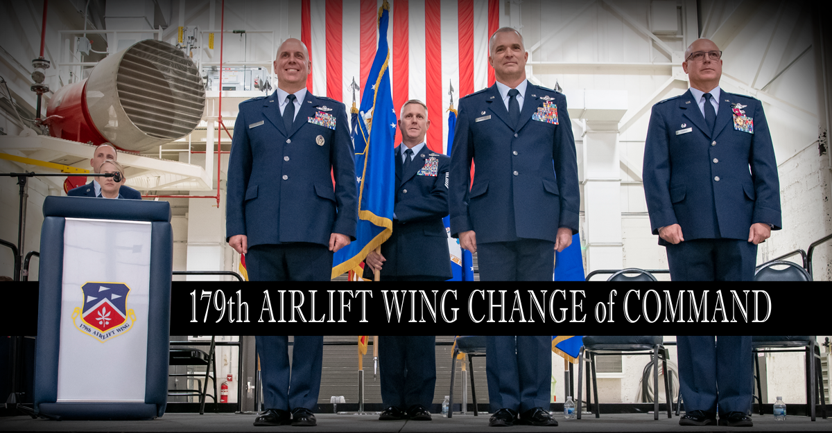 Air Guard leadership stand in front of colors.