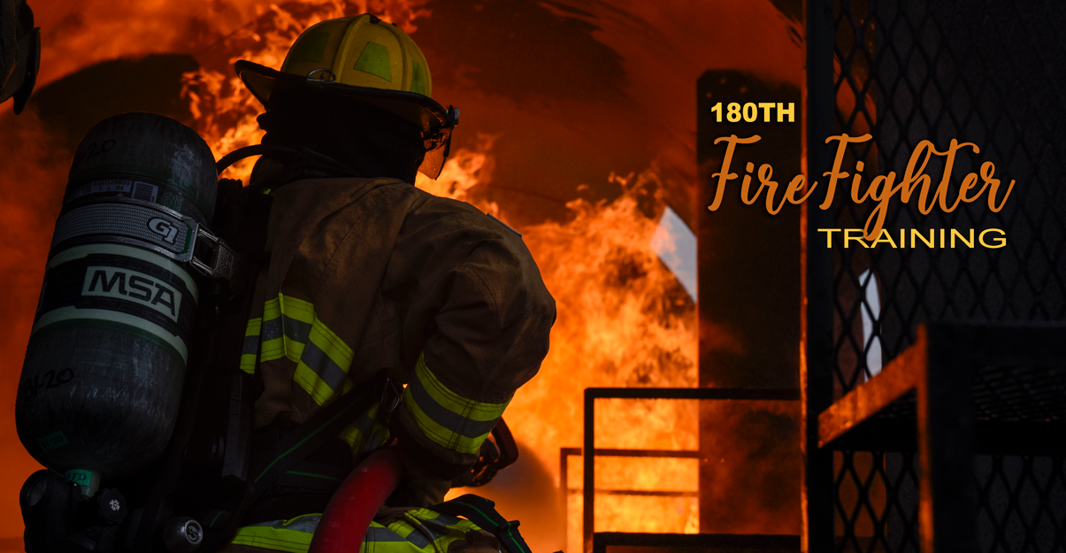 Back of firefighter putting standing in front of a fire