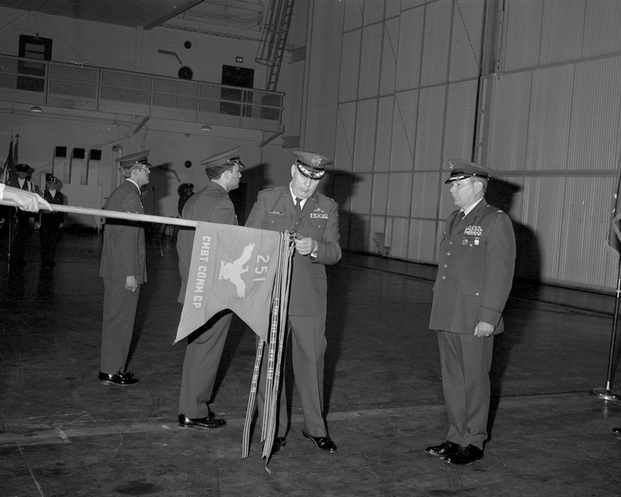 Black and white photo of adding streamer to guidon.
