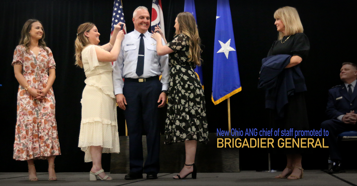 The family of Brig. Gen. David B. Johnson pins on his one-star rank insignia.