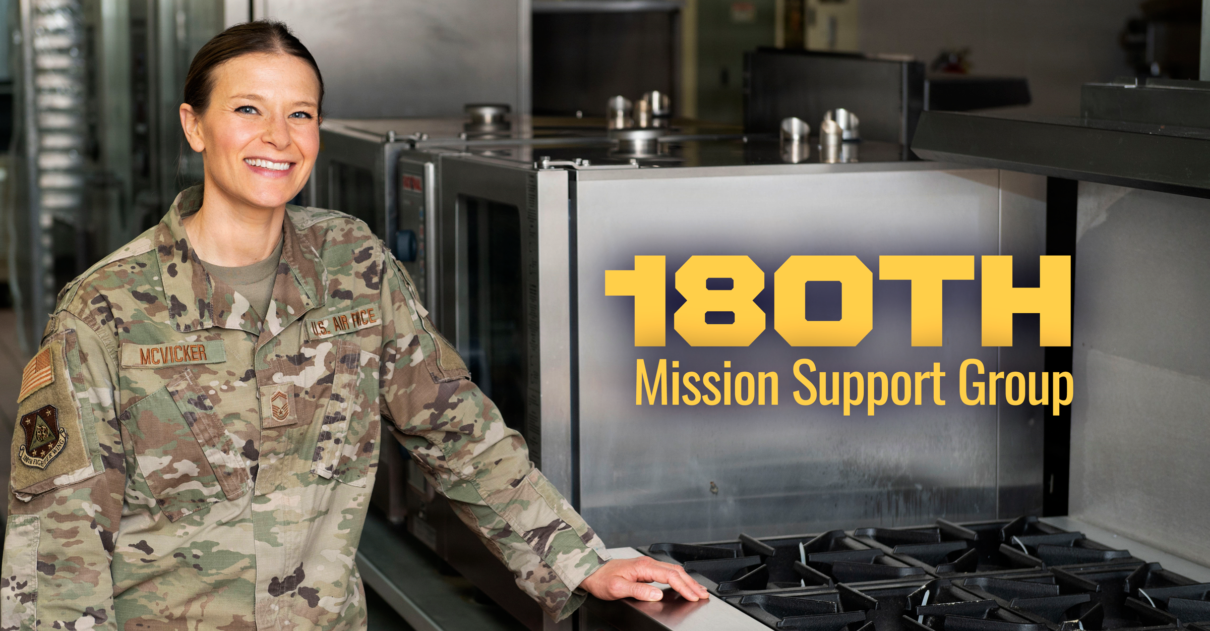 Senior Master Sgt. Ariel McVicker poses next to stove