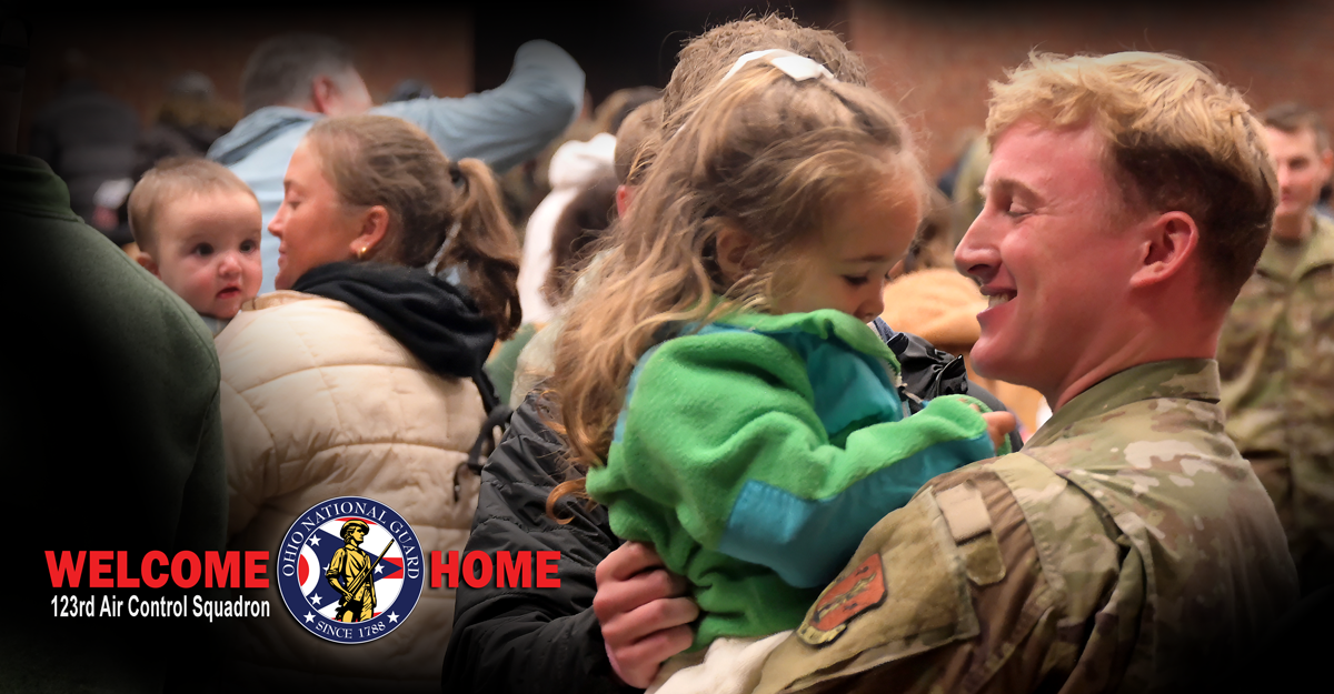 Airman holding a child
