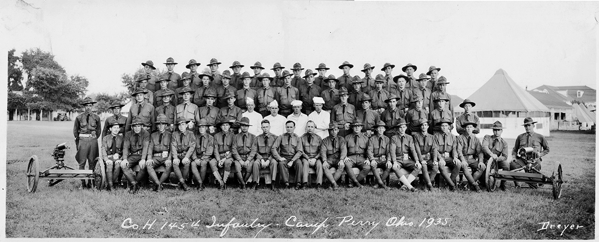 Company H, 145th Infantry sit outside for formal group pic in 1935
