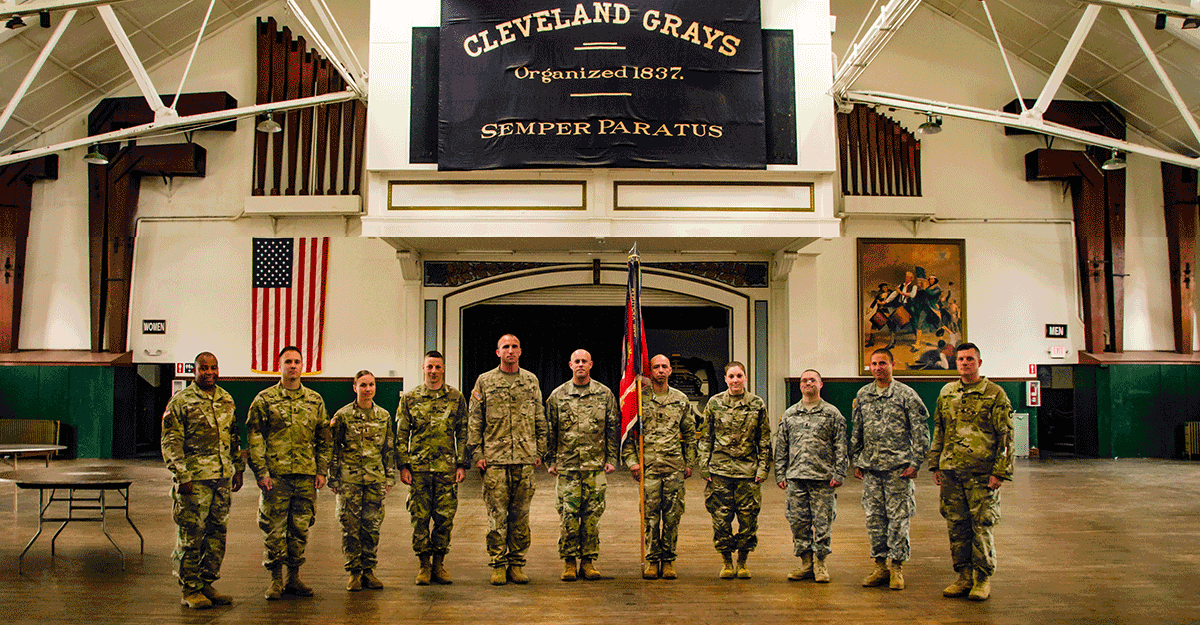 Members of the 112th Engineer Battalion stand for a photograph on the drill floor.