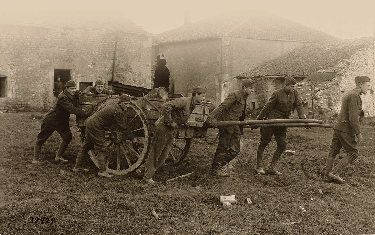 Sepia-tone photo of Artillery doing salvage workwith wagon in France.