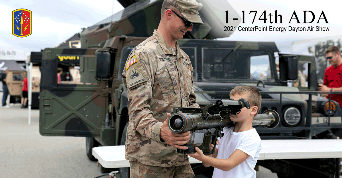Soldier shows boy a missile. 