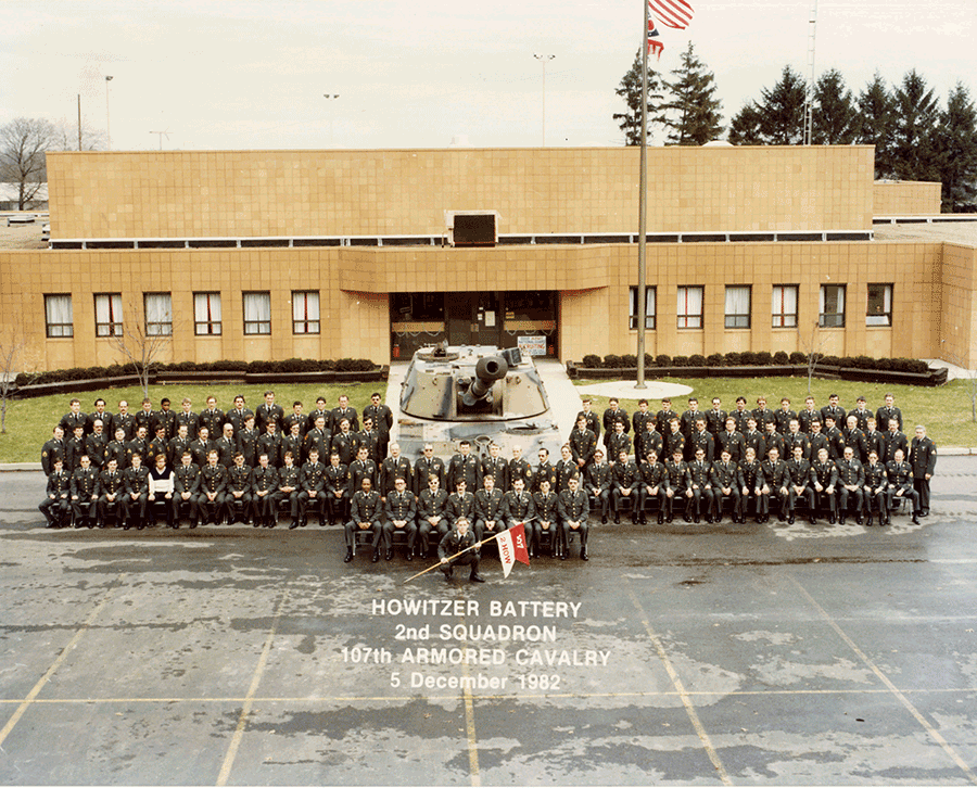 Soldiers in group photo in fron t of armory.
