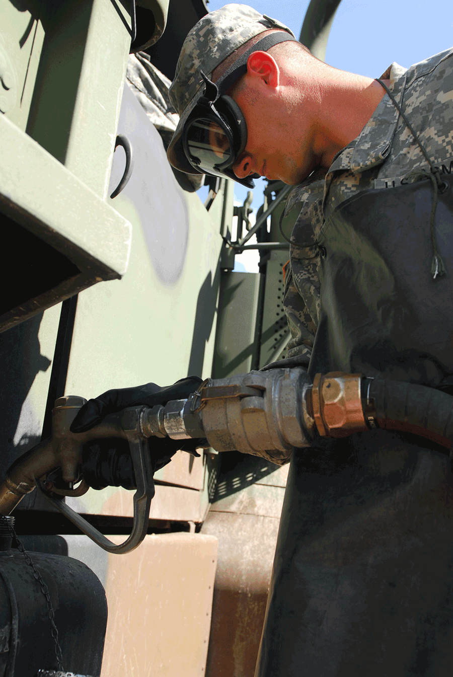 Soldier puts gas into tank.