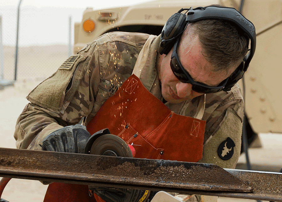 Soldier grinding metal. 