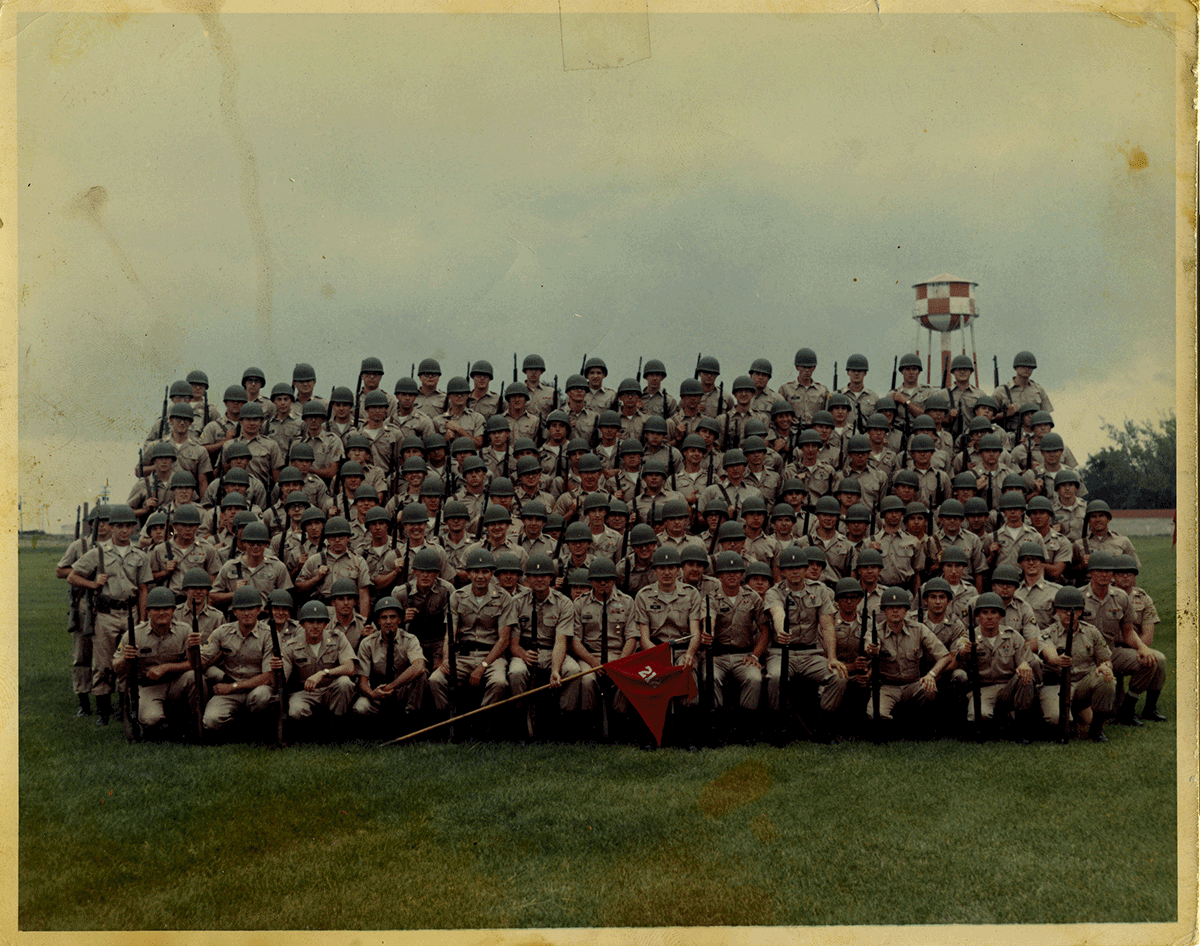 Color photo of Soldiers on bleachers fro group photo.
