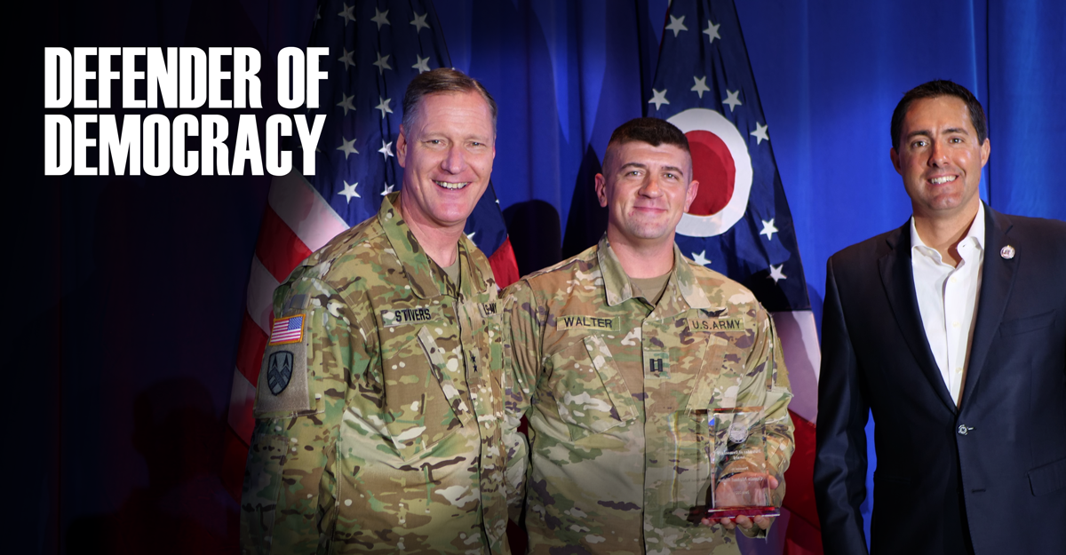 Maj. Gen. Steve Stivers, Capt. Michael Walter and Ohio Secretary of State Frank LaRose stand in front of Ohio and American flags