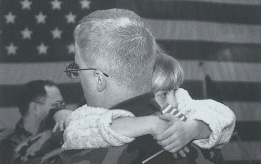 Shaina, daughter of SSG Jack McNeely, clings to her father before he leaves for nine months in Bosnia. McNeely, a member of the West Virgina National Guard, is a print journalist assigned to the 196th MPAD. R

