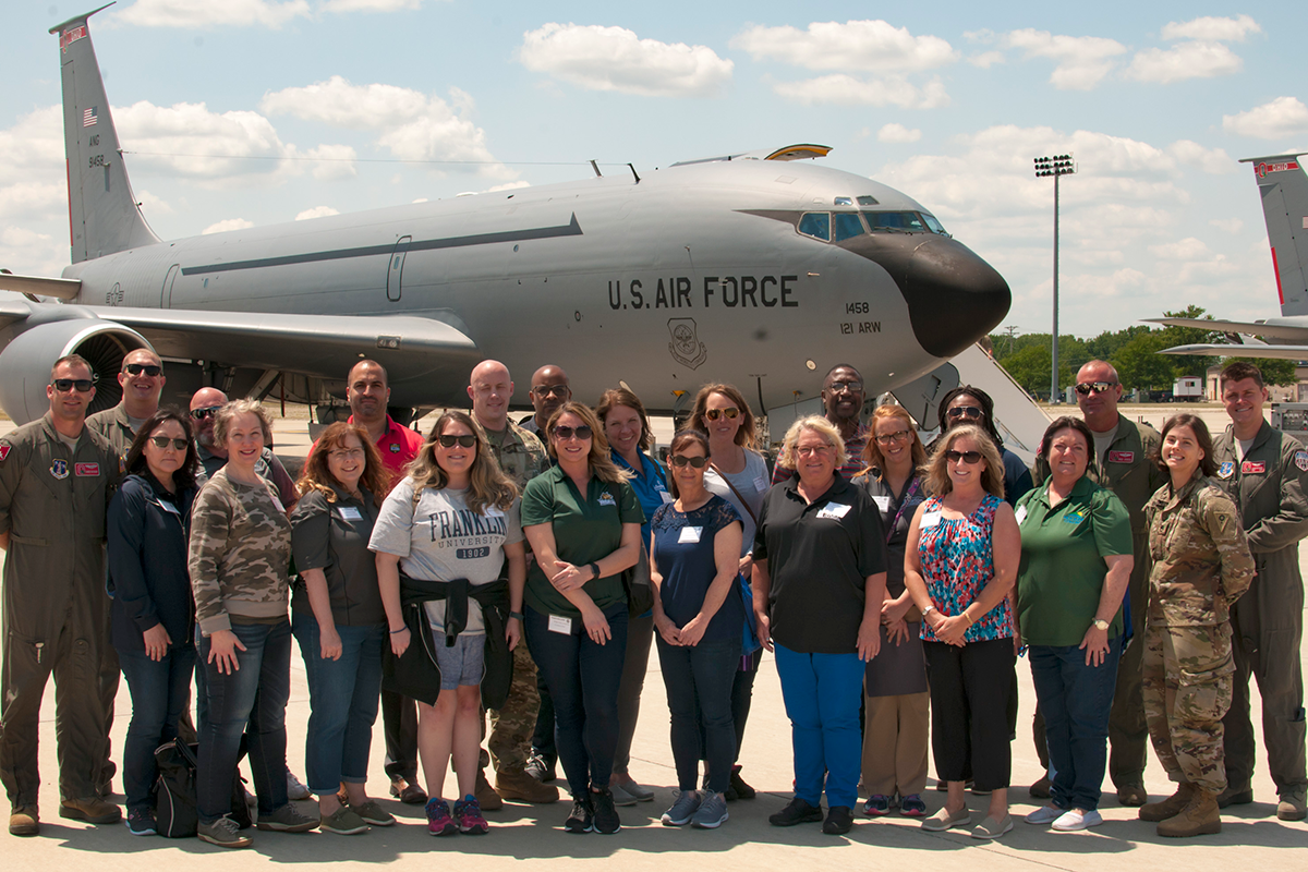 Group in front of aircraft.