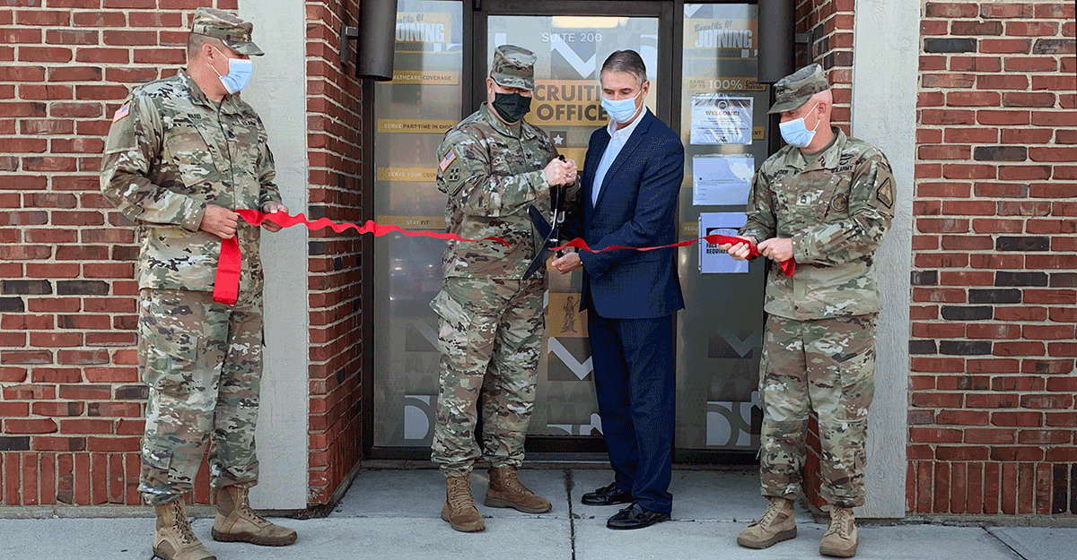Col. Daniel Shank and Vandalia Mayor Richard Herbst cut a red ribbonin front of doors.