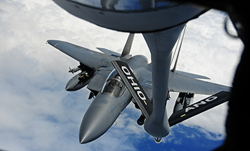 Ohio Air National Guard KC-135 Stratotanker preparing aerial refueling to a F-15E Strike Eagle fighter.