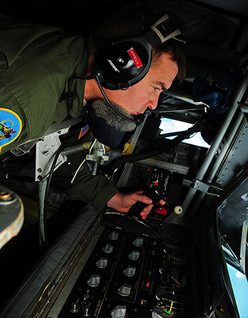 Ohio Air National Guard KC-135 Stratotanker preparing to provide aerial refueling to a group of F-15E Strike Eagle fighters.
