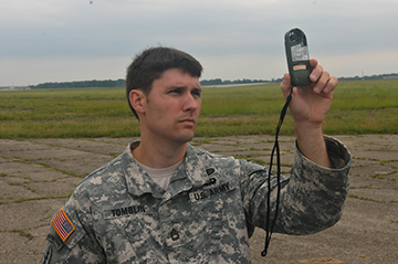 Sgt. First Class Billy Tomblin checks the wind speed before a parachute training jump by Soldiers of Company B, 2nd Battalion, 19th Special Forces Group (Airborne) on June 8, 2014, at Rickenbacker Air National Guard Base in Columbus, Ohio. More than 30 members of the Special Forces unit were conducting a jump into the drop zone at Rickenbacker as part of their weekend drill training. 