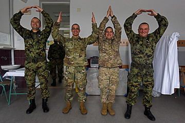 A group of medical personnel from the Ohio National Guard and Serbian Armed Forces form the iconic “O-H-I-O” .