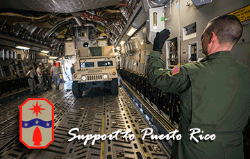 An Airman guides an Ohio Army National Guard Humvee onto a C-17 Globemaster III.