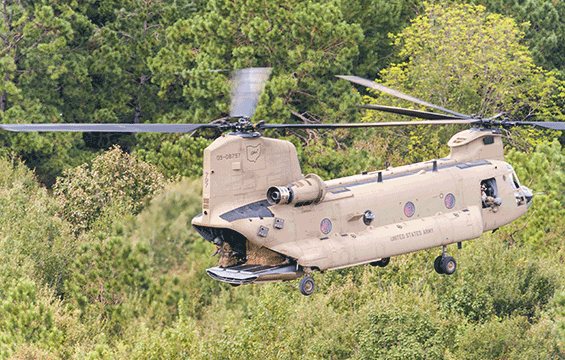 An Ohio Army National Guard CH-47 Chinook helicopter delivers hay to stranded livestock.