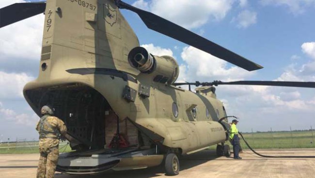 Soldiers load Buckeye II, a Chinook helicopter with food and water.