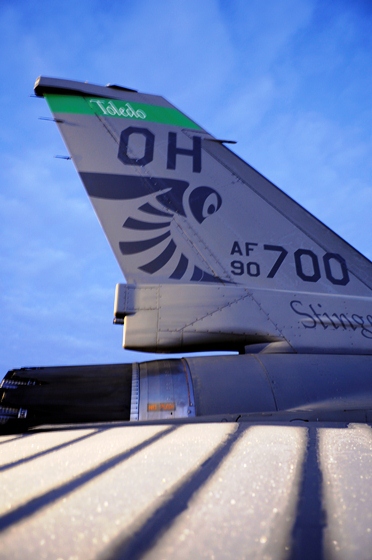 Tail of an F-16CG aircraft defrosting on the flightline in the early morning hours.
