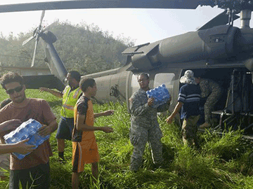 Ohio Army National Guar Pfc. Carlina Croston unloads supplies off a helicopter in Puerto Rico. The 137th Signal Company, which is based in Newark, spent a month on the island helping residents recover from Hurricane Maria.