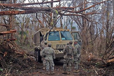 Soldiers with the Puerto Rico Army National Guard’s 190th Engineer Battalion work to clear a roadway in Cayey, Puerto Rico.