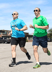 First Sgt. Adam Wells (left),  of 73rd Troop Command, and 1st Sgt. Ryan Scarberry, of the 122nd Army Band, race to the finish line.