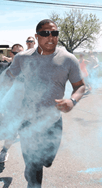 Senior Airman Marquis Leatherbury, an aerospace ground equipment specialist with the 179th Airlift Wing, has colored powder thrown on him while he competes in the Ohio National Guard Sexual Assault Awareness and Prevention Month 5K Color Run/Walk.