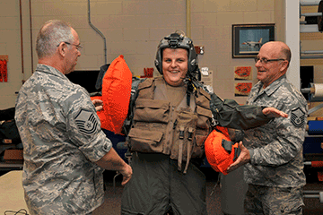Airmen help teen trying on gear.