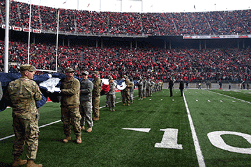 Ohio National Guard Soldiers and Airmen unfurl a giant U.S. flag.