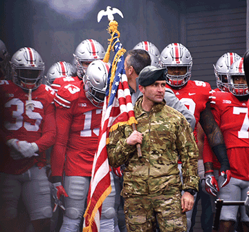 Ohio Army National Guard Staff Sgt. Christopher Richman, of B Company, 2nd Battalion, 19th Special Forces Group, prepares to run onto the field with the Ohio State football team.