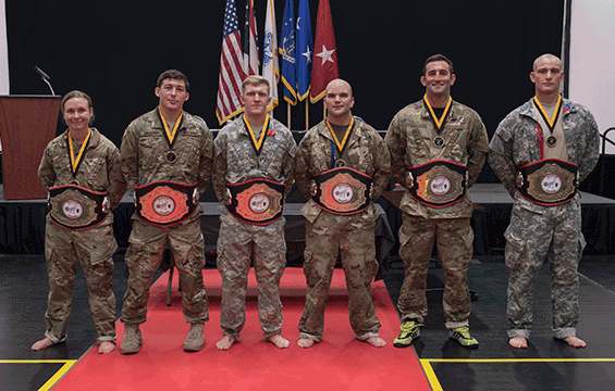 Soldiers stand in line wearing theri respective championship belts.