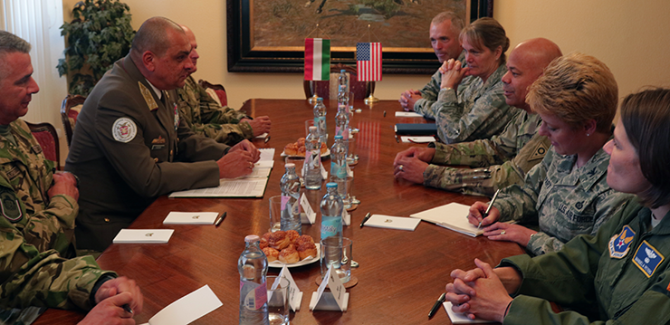 Lt. Gen. Ferenc Korom speaks with an Ohio National Guard delegation at table.