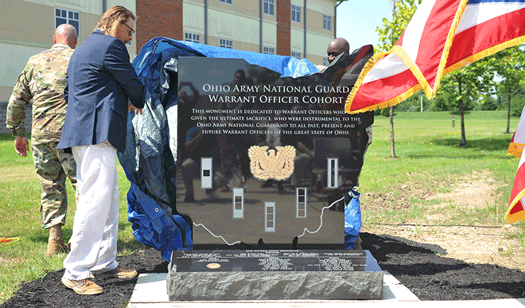 Retired Chief Warrant Officer 5 D.K. Taylor (left), assists in the unveiling of the Ohio Army National Guard Warrant Officer Cohort monument July 9, 2018, at the 147th Regiment (Regional Training Institute) in Columbus, Ohio. More than 100 current and retired warrant officers, special guests and senior OHARNG leadership attended the ceremony, which coincided with the anniversary of the U.S. Army Warrant Officer Cohort’s 100th birthday.