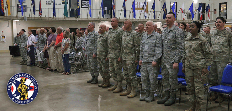 Soldiers and Airmen stand at attention in the srmory drill floor.