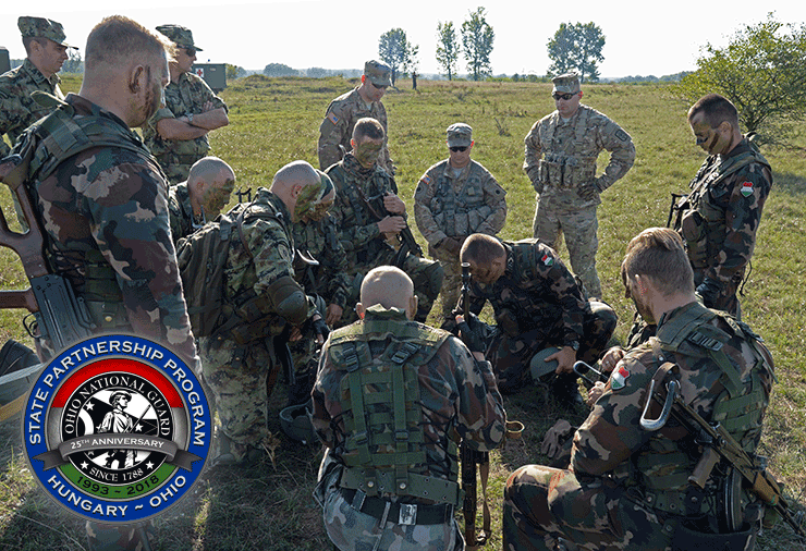 Ohio Soldiers review plans in field with hungarian Soldiers.