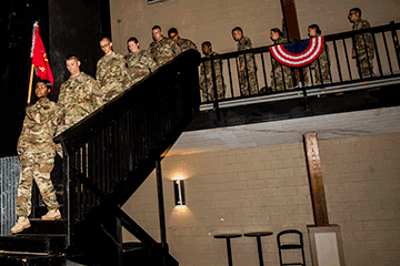 Soldiers decend staircase in church.