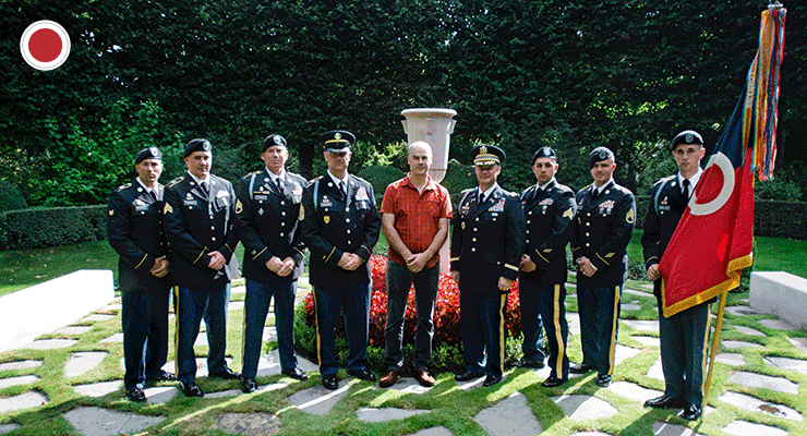 Retired Belgian army Sgt. Maj. Peter Stassen (center) stands with the command team and other Soldiers from the 37th Infantry Brigade Combat Team at Flanders Field American Cemetery.