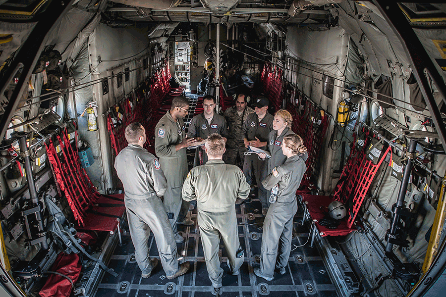Aircrew talk inside a C-130H Hercules.