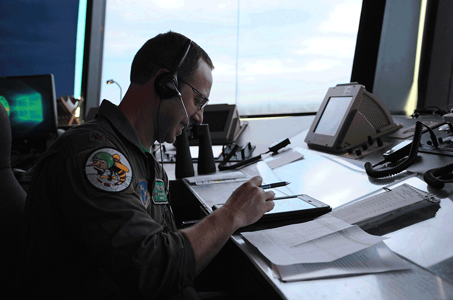Pilot at desk in control tower.