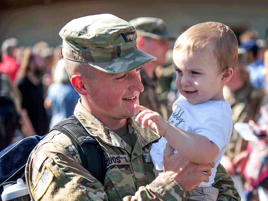 Soldier holds his son.