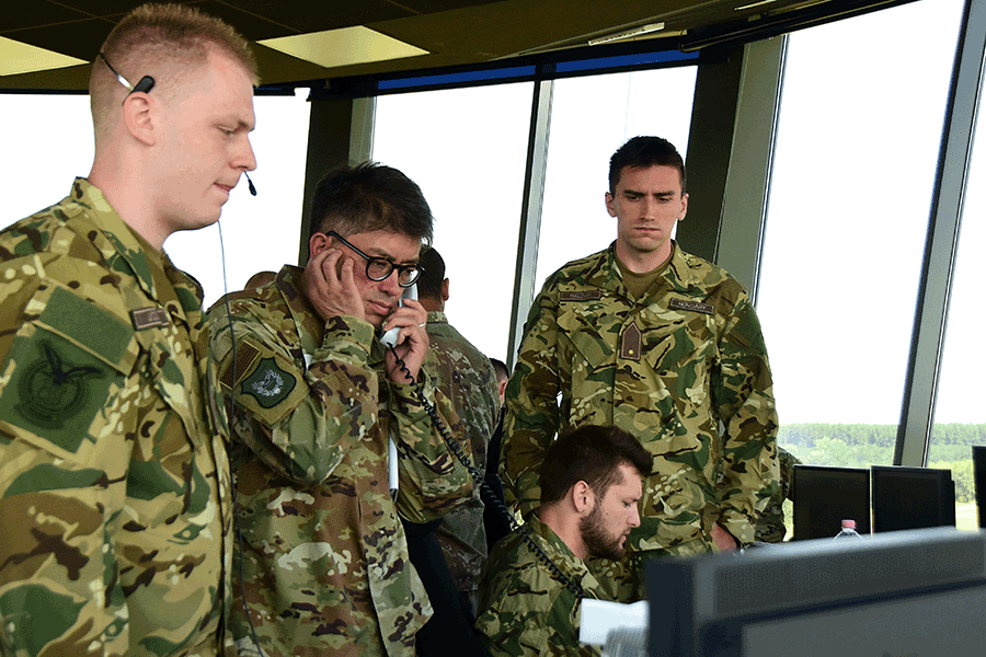 U.S. Air Force Lt. Col. Allen Kao answers the phone and works alongside his Hungarian counterparts in air terminal.