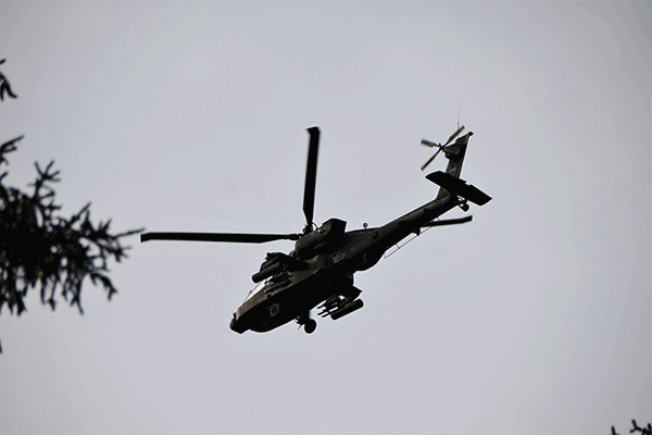 An AH-64 Apache helicopter in air.
