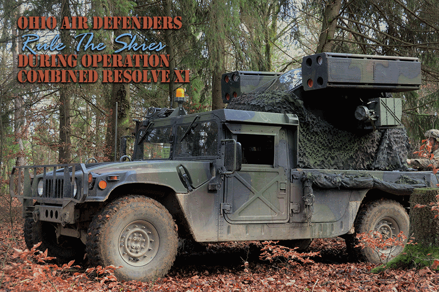 Air Defense Artillery Humvee Avenger weapons system disquised in camo in woods.