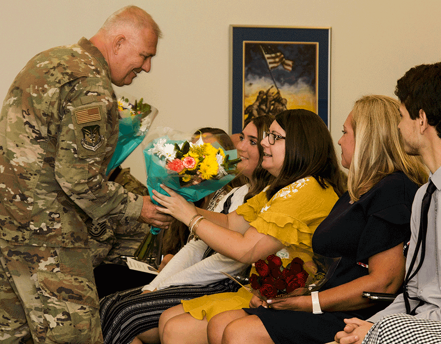 Col. Wade D. Rupper presents flowers to his family.