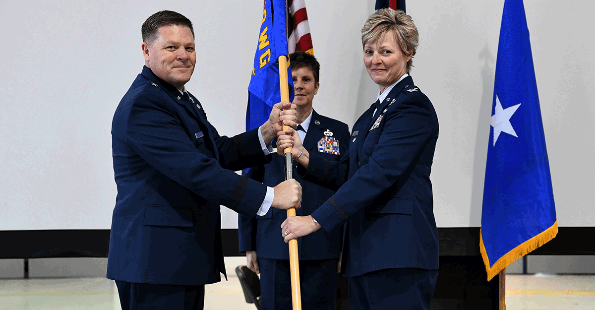 Brig. Gen. James R. Camp hands the guidon to Col. Kimberly A. Fitzgerald.